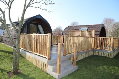 a wooden deck with a gazebo in a yard at The Kellbank in Gosforth