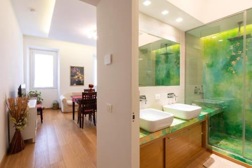 a bathroom with two sinks and a large mirror at Trevi Rome Central House in Rome