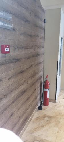 a wall made of wood with a fire extinguisher and a bucket at Kraljevi Cardaci 9D 12- Sunny view in Kopaonik