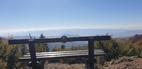 a wooden bench sitting on top of a mountain at Kraljevi Cardaci 9D 12- Sunny view in Kopaonik