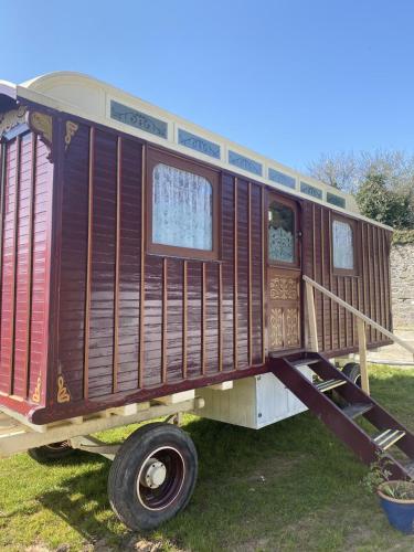 a train car is sitting on the grass at Vintage Showman's Wagon For Two Close to Beach in Plymouth