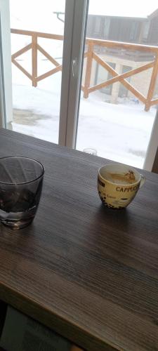 a wooden table with a bowl on top of a table at Kraljevi Cardaci 9D 12- Sunny view in Kopaonik