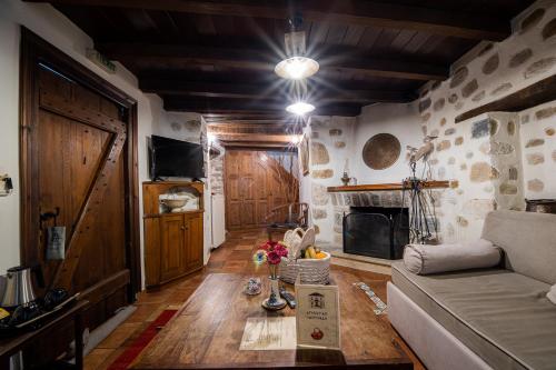 a living room with a couch and a table at Archontiko Naoumidi in Portariá