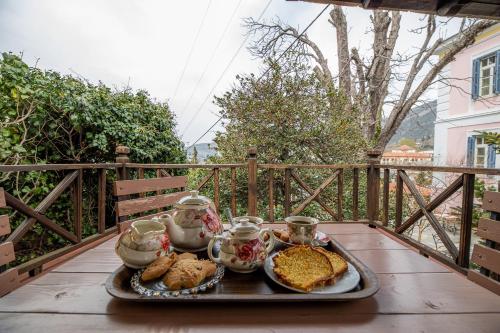 a tray of food on a table on a balcony at Archontiko Naoumidi in Portariá