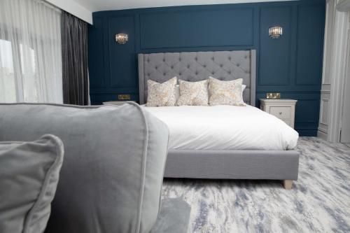 a bedroom with a large bed and a couch at Erris Coast Hotel in Geesala
