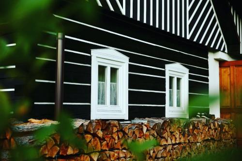 a black and white building with two windows at Roubenka 1818 in Všelibice