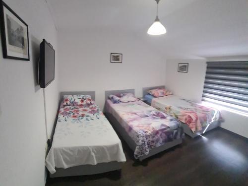 two twin beds in a room with a window at Hostel FM in Mostar