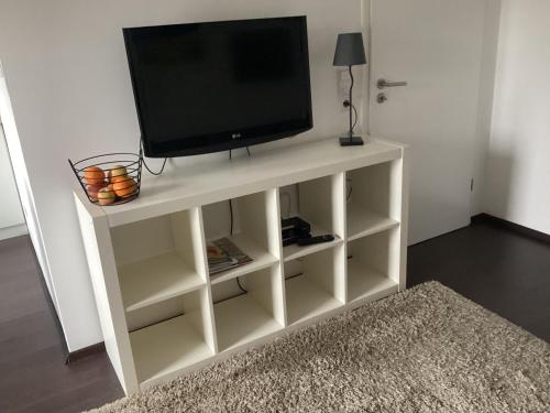 a white entertainment center with a television on it at Relaxen vor den Toren Bambergs in Bischberg