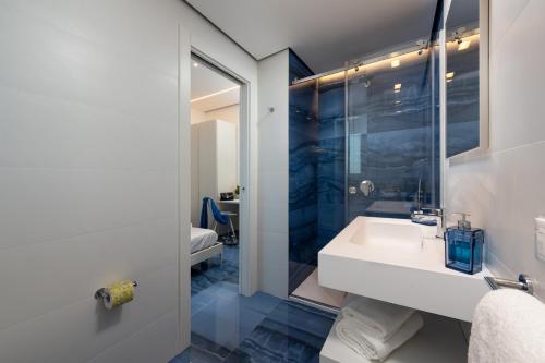 a bathroom with a sink and a shower at Le Maree Comfort Rooms in San Vito lo Capo