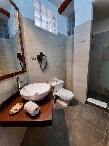 a bathroom with a sink and a toilet at Hotel Sueños del Inka in Cusco