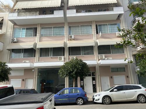 un bâtiment avec des voitures garées devant dans l'établissement City House Elegant, à Kalamata