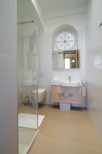 a bathroom with a sink and a toilet and a mirror at Luxury Apartments Centre of Opatija in Opatija