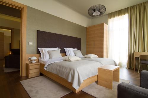 a bedroom with a large bed with white sheets and pillows at Luxury Apartments Centre of Opatija in Opatija
