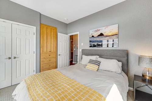 a bedroom with a bed with a yellow blanket on it at Oceanside Oasis in Oceanside