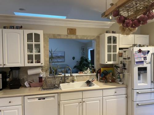 a kitchen with a sink and a white refrigerator at 5BRwithBand&Piano setup Private Gym Theater&Entry at Cherry Hill in Cherry Hill