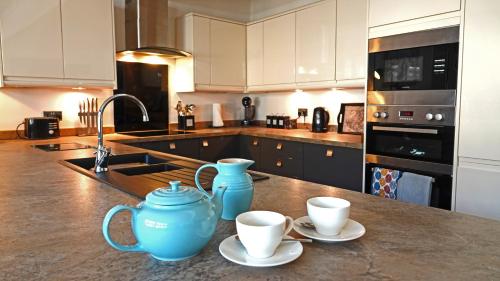 una cocina con dos tazas azules y dos tazas en un mostrador en Merchants Rest, en Dartmouth
