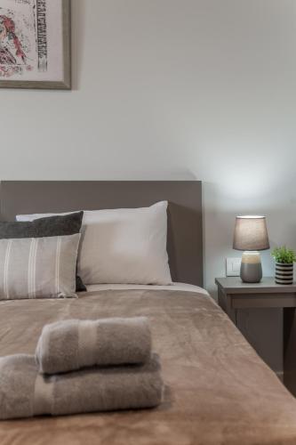 a bedroom with a bed with two towels on it at Eva's Studio in Heraklio