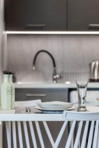 a kitchen counter with a sink and a glass at Eva's Studio in Heraklio