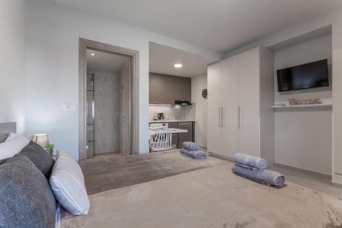 a living room with a bed and a kitchen at Eva's Studio in Heraklio