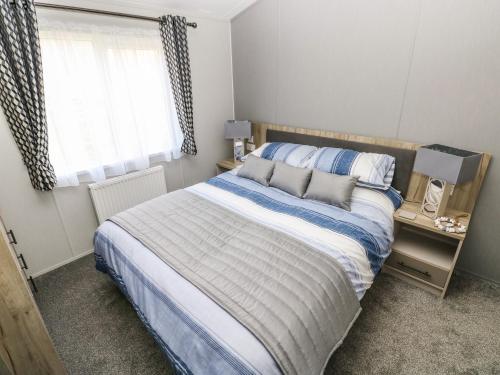 a bedroom with a bed and a window at 69 The Paddocks in Carmarthen