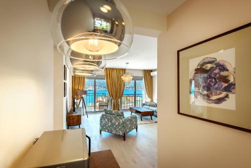 a living room with a couch and a chandelier at 2MONTENEGRO LIMETA APARTMENTS with pool in Kotor