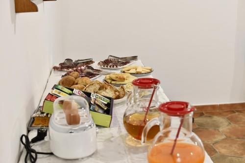 a table with a bunch of food and some drinks at Tenute Efis in Galtellì