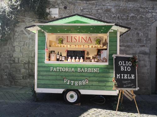 a food cart with a sign in front of it at La Fattoria Barbini B&B in Viterbo