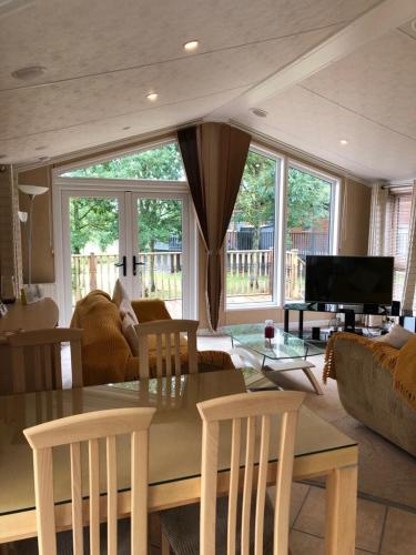 a living room with a table and chairs and a couch at Gold Caravan in Harrietsfield