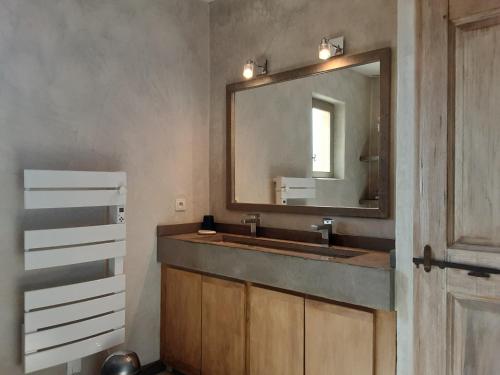a bathroom with a sink and a mirror at La maison de Jérôme et Virginie in Aigaliers