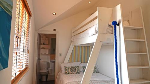 a room with a bunk bed and a bathroom at Merchants Rise in Dartmouth