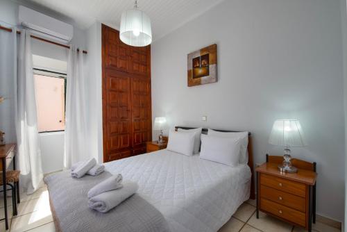 a bedroom with a bed with two towels on it at Paxos Center in Gaios