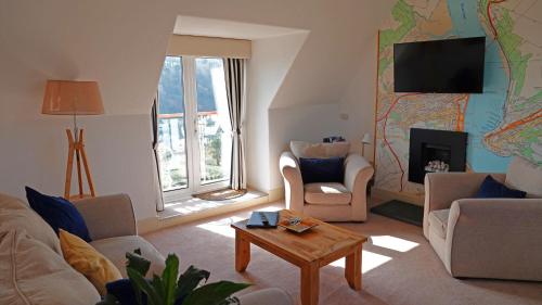 a living room with a couch and a table at The Lookout at Lauriston in Dartmouth