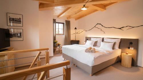 a bedroom with a bed with a mountain design on the wall at Boutique Hotel Soyka in Špindlerův Mlýn