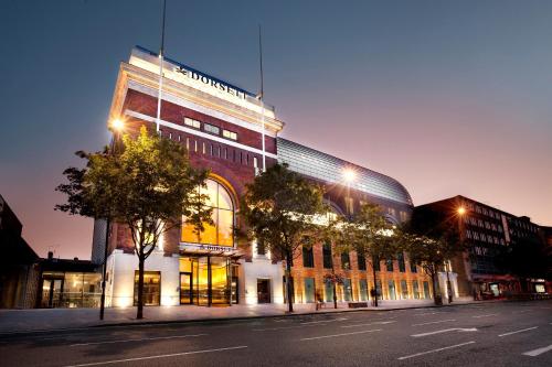 a building with a sign on the side of it at Dorsett Shepherds Bush London in London