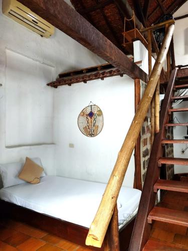 a bunk bed in a room with a ladder at Giron Chill Out Hotel Boutique in Girón