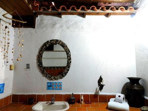 a bathroom with a sink and a mirror on the wall at Giron Chill Out Hotel Boutique in Girón