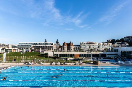 une grande piscine avec des gens qui nagent dedans dans l'établissement Les Fées Mer - Dieppe - Normandie, à Dieppe