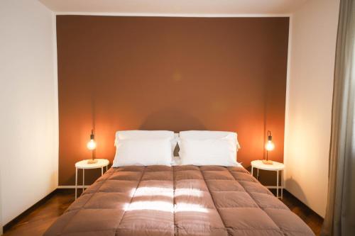 a bedroom with a large bed with two lamps at VILLA LAURETO - By Apulia Hospitality in Selva di Fasano