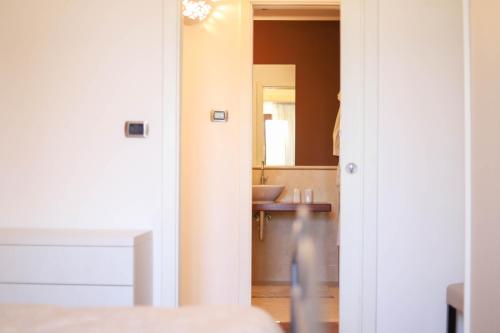 a bathroom with a sink and a mirror at VILLA LAURETO - By Apulia Hospitality in Selva di Fasano
