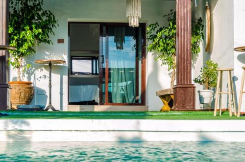 a house with a swimming pool in front of a house at Casona de Tao in Tiagua