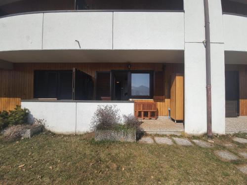 a white building with a table in front of it at Apartment San Giacomo - Brentonico in Brentonico