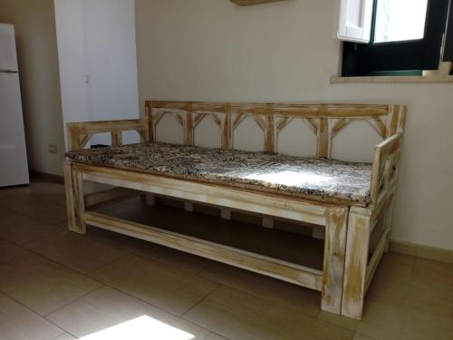 a wooden frame bed in a room at Appartamento L'Ammiraglio in Trapani