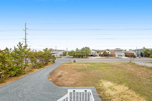 an empty street with a white bench on the side of the road at Fenwick Island --- 1710 Coastal Hwy in Fenwick Island