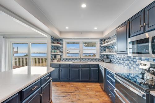 a kitchen with navy blue cabinets and white countertops at Fenwick Island --- 1710 Coastal Hwy in Fenwick Island