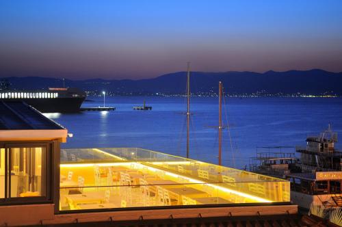 a balcony with a view of the water and a boat at Horasan Hotel in Cesme