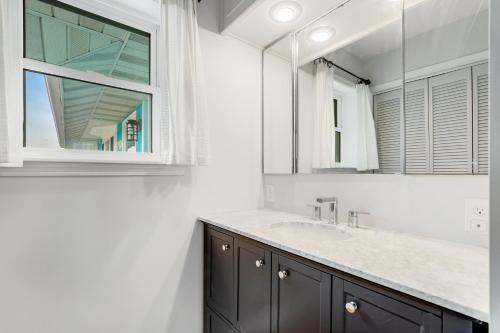 a bathroom with a sink and a mirror at Fenwick Island --- 1710 Coastal Hwy in Fenwick Island
