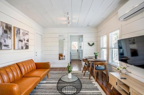 a living room with a couch and a table at Historic Heights Artist Bungalow #3 in Houston