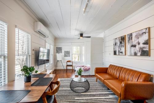 a living room with a couch and a table at Historic Heights Artist Bungalow #3 in Houston