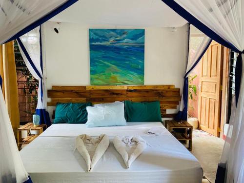 a bedroom with a bed with two towels on it at Salty's Kitesurf Village in Kilifi