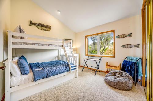 a bedroom with two bunk beds and a desk at Pelican House in Fort Bragg